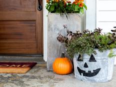 A Galvanized Pumpkin Planter Sitting By Front Door