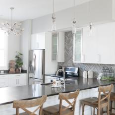White Open Plan Kitchen With Gray Backsplash