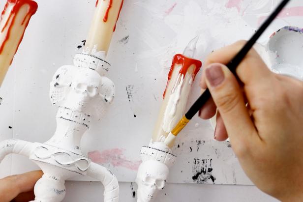 Use a smaller brush to paint the candles an off-white shade.