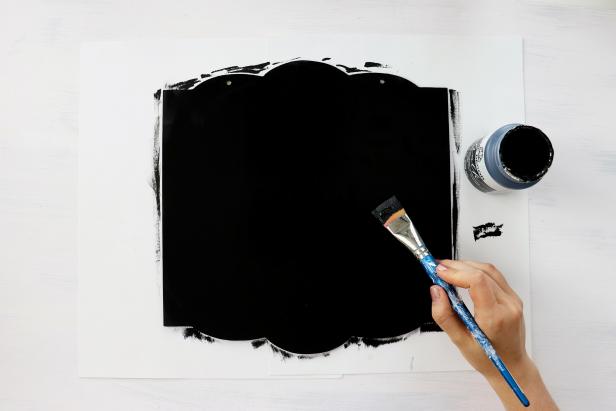 Remove all embellishments from your Halloween sign and paint it black.