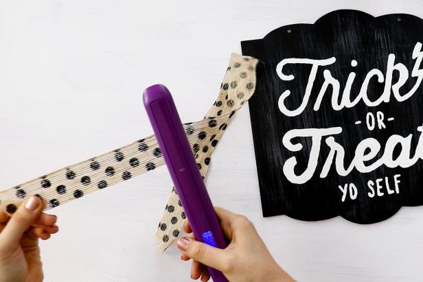 Run the sign's original bow through a hair straightener to smooth it out.