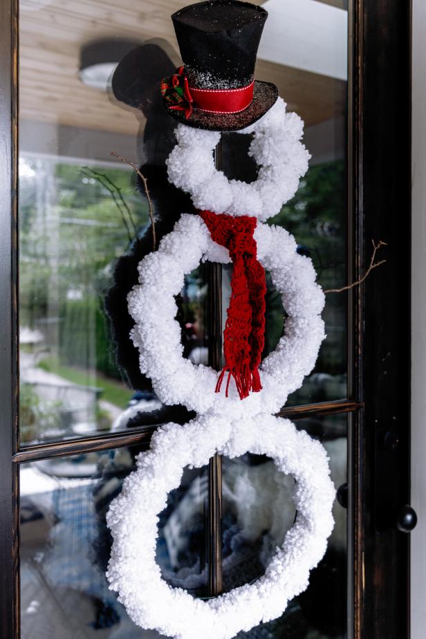 Nothing sets the tone like a festive front door. If you’re into some light crafting during the holidays, this dapper snowman is a must-make. It’s essentially three wire wreath forms covered in DIY pom-poms. We love that it’s easy to make and even easier to hang (one Command Hook, done!)  It also folds up quickly when it's time to store it for next year. 