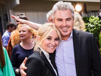 Brady Bunch cast members Maureen McCormick and Christopher Knight in front of the recently renovated Brady home in Studio City, California, as seen on A Very Brady Renovation.
