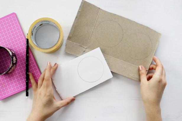 Trace the outside of the duct tape roll onto cardboard twice and trace the inside of the roll onto foam board once. Cut the cardboard circles out with scissors and then use a craft knife to cut out the foam circle.