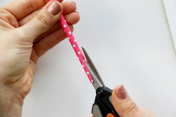 Use your ruler to draw a straight line down the length of your straw. Cut down that line using scissors for shorter straws and a craft knife for longer straws.