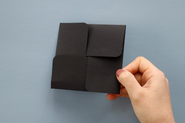 Fold each tab into the center, overlapping the tabs, to close up the card.