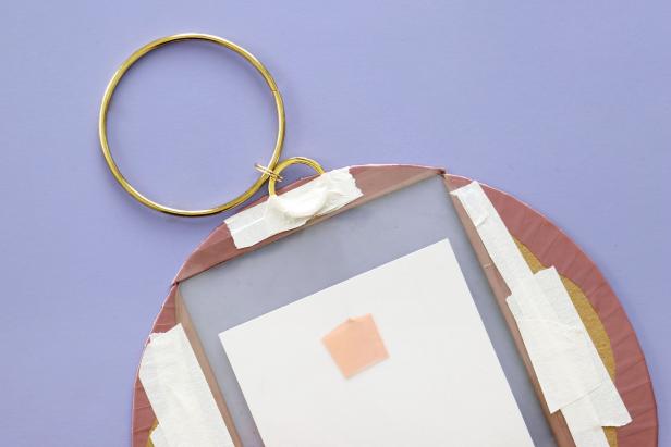 Next, attach a gold bracelet and keyring with a large jump ring. Tape to the back of the picture frame.