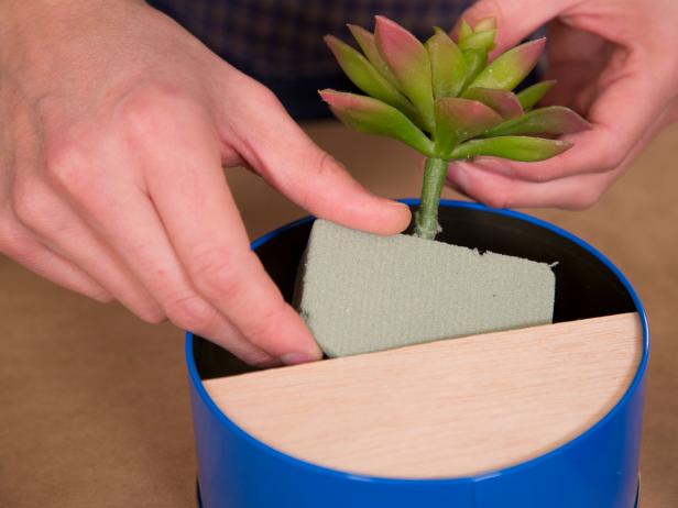 If using faux plants, cut a cube of floral foam to fit inside, snip the stems at an angle then push them inside the foam.
