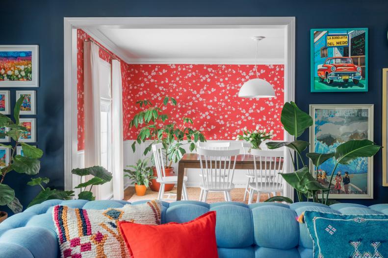 When choosing colors for rooms which open up to one another, always take into consideration room to room harmony to ensure the proper flow from space to space. The dark navy walls of the living room created a moody vibe, but the cheerful cherry red just beyond it in the dining room helps balance out the darkness.