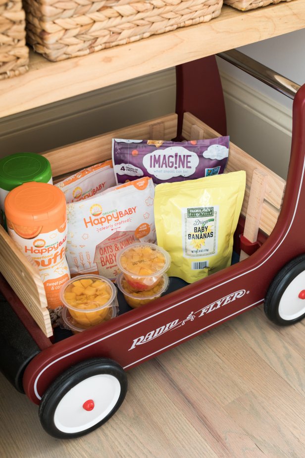 Encourage your little ones to fetch their own healthy snacks by keeping them at kid height and in a rolling vessel that makes it easy to access and move to the dining table. This wooden cart has a vintage look and removable side panels for little ones to take out and put back their favorite parent-approved snacks.