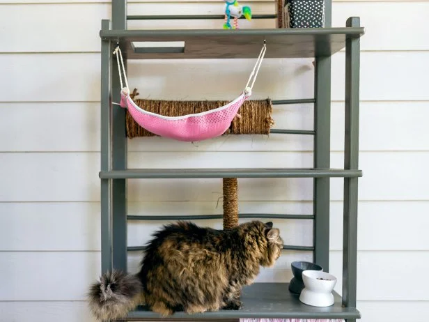 Now you can give your feline BFF impressive outdoor digs without spending big bucks on a cookie-cutter cat condo. Repurpose a thrift store find, like this wooden baker’s rack, into a high-rise cat tower complete with exclusive views, satisfying scratch posts and kitty hammock.
