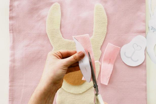Cut into the pattern to cut out the nose and ear shapes. Cut the nose shape from tan felt and the ear shapes from pink felt.