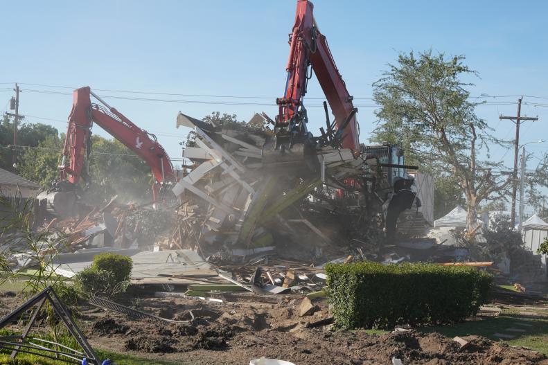 Dual excavators demolish the Mosley family's old house in Bakersfield, California, making way for their brand new home