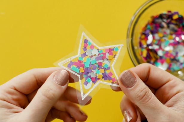 Make a magnet by tracing a simple shape like a star onto your page protector using a white paint pen. Sew half of the star closed and fill with confetti. Sew the other half closed and use packing tape to add a magnet to the back.
