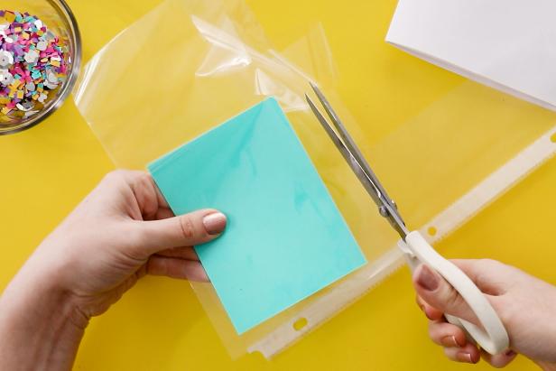 Use this same method to make a notebook by sewing one side of a page protector to folded scrapbook paper. Fill with confetti and sew closed. Cut and fold paper to fit inside and staple your notebook together.