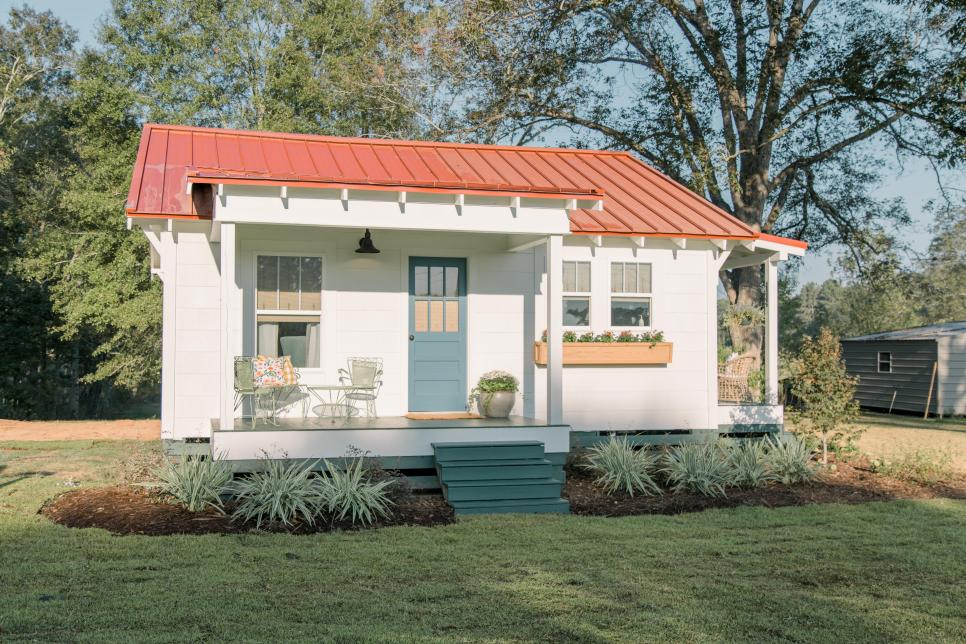 A sweet little house with blue door and red roof on HGTV's Home Town. #tinyhouse #hometown #tinyfarmhouse