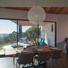 Midcentury Modern Dining Area With White Pendant