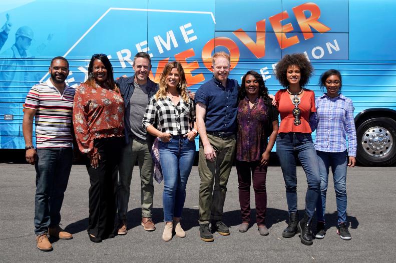 The Washington family poses with the Extreme Team in front of the Extreme Makeover bus. Pictured: Dad Thom Washington, sister Terri Lynn Henderson, designers Darren Keefe and Carrie Locklyn, host Jesse Tyler Ferguson, wife Stephanie Washington, designer Breegan Jane, daughter Kennedi Washington