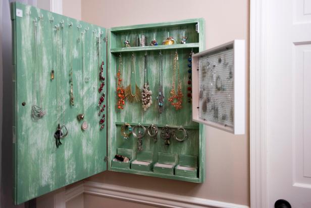 Building a wall-mounted jewelry cabinet is an inexpensive way to keep your trinkets organized.