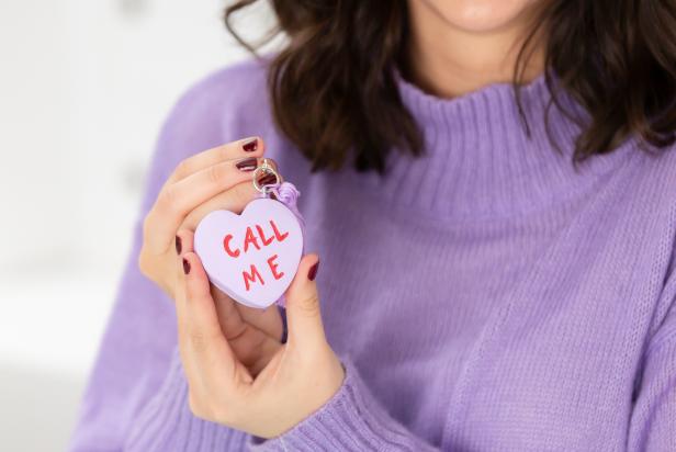 Woman Holding Clay Heart That Says Call Me 
