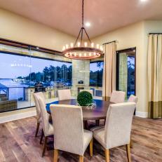 Waterfront Dining Area With Round Chandelier