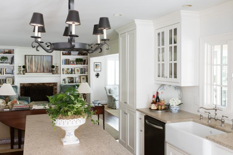 This renovated kitchen features white cabinets and granite counters.