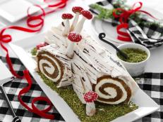 This variation on the classic French Buche de Noel combines a mouthwatering pumpkin roll with cream cheese frosting and chocolate bark. It’s decorated with edible mini mushrooms and rests on a bed of mossy-looking ground pistachios. 