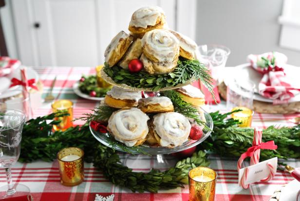 This centerpiece doubles as festive table decor!  Use our recipe for quick biscuit cinnamon rolls, which is the easiest version of cinnamon rolls to make.  Once baked and glazed, stack them high on tiered cake pedestals within easy reach in the center of your table.   