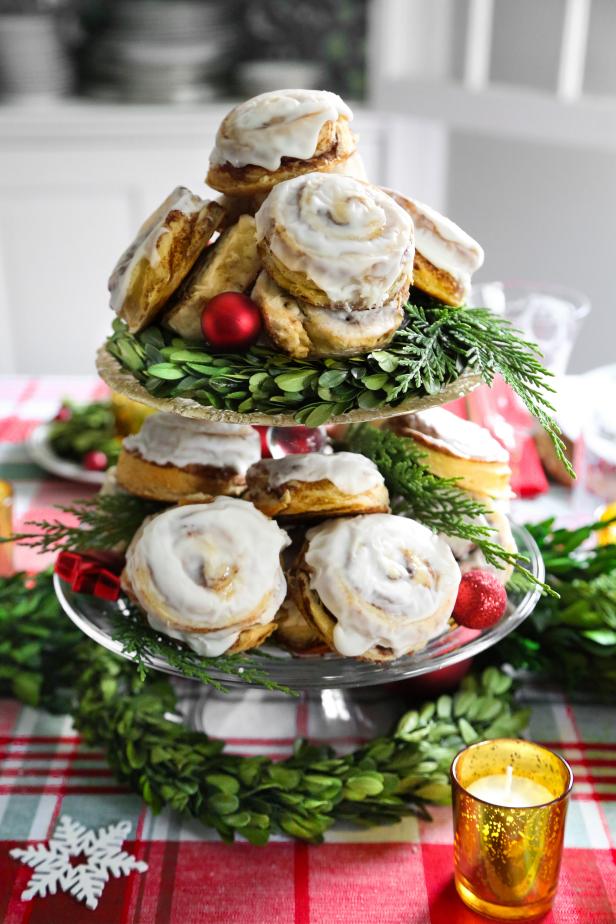 This centerpiece doubles as festive table decor!  Use our recipe for quick biscuit cinnamon rolls, which is the easiest version of cinnamon rolls to make.  Once baked and glazed, stack them high on tiered cake pedestals within easy reach in the center of your table.   
