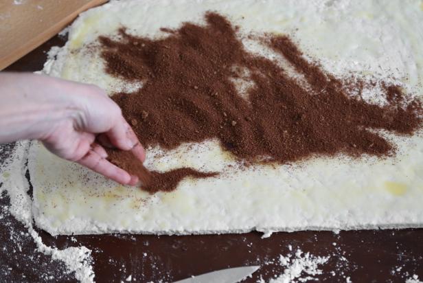 Mix together the sugars, cocoa powder and cinnamon in a small bowl. Sprinkle the mixture over the melted butter and spread evenly over the dough’s surface.