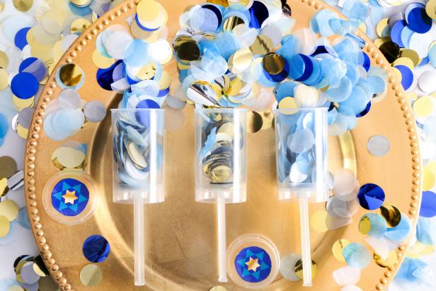 Confetti poppers are an exciting addition to a Hanukkah table setting. They’re a colorful, effervescent way of celebrating, and pretty enough to use as table decor. 