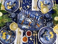 A mélange of patterned plates don the table in unifying blue hues. Don’t be afraid to mix things up by pairing all kinds of prints together.  You may find all the items you need in your very own kitchen cupboards.
