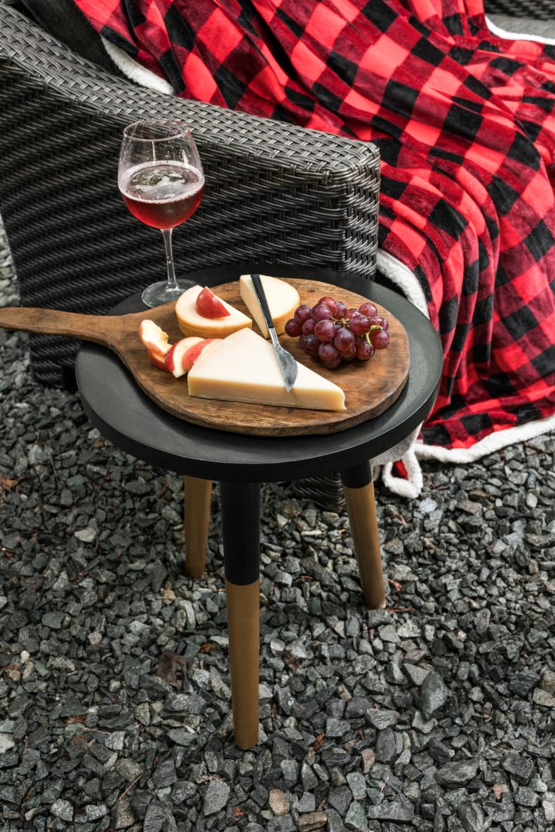 When space around a fire pit is at a premium, choose hardworking furniture pieces which serve more than one purpose. To add surface space for wine and cheese, this occasional table comes in handy; however, it can also function as an extra stool for guests to keep warm around the fire.