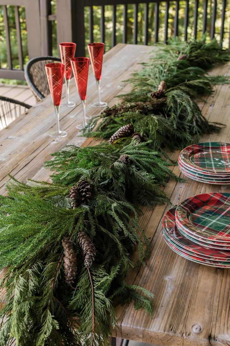 Obviously, you're looking at a live pine cutting, right? Nope! This farm table is styled with faux pine garland runner which is virtually identical to the live version. One of the pluses to working with faux pine is the lack of browning from poor air circulation and dehydration. 