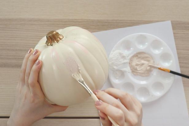 Paint two coats of paint onto your pumpkin, letting it dry between each coat. Don’t add the baking powder until you’re ready to paint each coat, since adding the baking powder makes it dry very quickly.
