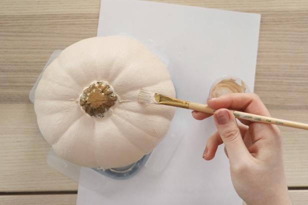 Paint two coats of paint onto your pumpkin, letting it dry between each coat. Don’t add the baking powder until you’re ready to paint each coat, since adding the baking powder makes it dry very quickly.