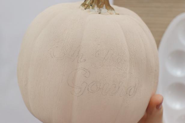 Optionally, print out a fun saying from the computer and cut it out. Color on the back with a pencil. Tape it onto the pumpkin and trace around the outlines with a sharp pencil. When you remove the paper, the design will have been transferred.