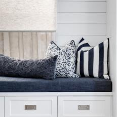 Built-In Storage Beneath Blue and White Dining Nook Seat 
