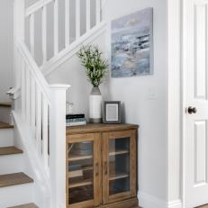 Contemporary White Entryway With Staircase and Glass Storage Cabinet 
