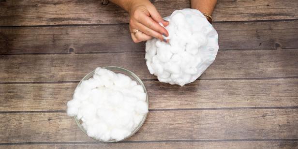 This shower cap is being turned into a wig for a Big Bad Wolf dog Halloween costume that goes alongside a Little Red Riding Hood costume. Cotton balls are glued on to resemble hair.