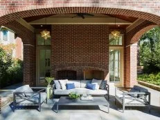 This covered patio includes a fireplace and log storage.