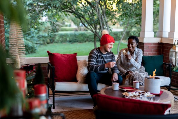 A Couple Makes S'mores On a Front Porch