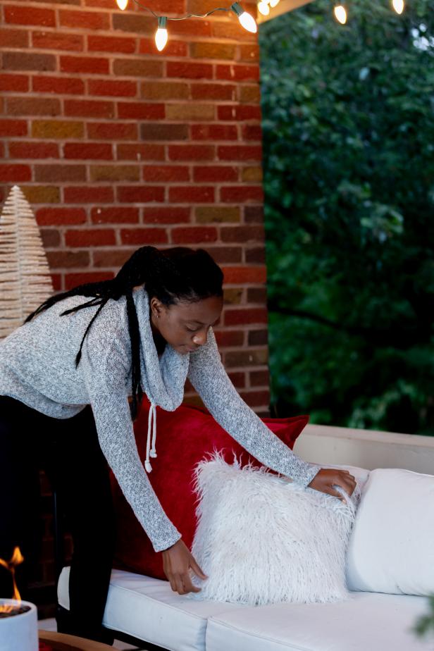 These fluffy, fuzzy pillows are added to an outdoor sofa to get it ready for the holiday season. The entire porch has been overhauled to accommodate for winter enjoyment.