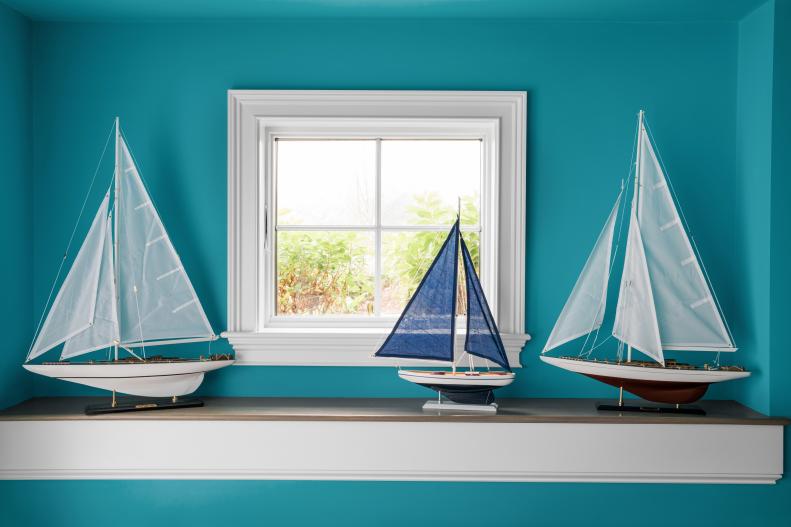 A curated selection of model sailboats on the bottom floor window ledge reflects the big sailing culture of this active Newport, Rhode Island community.