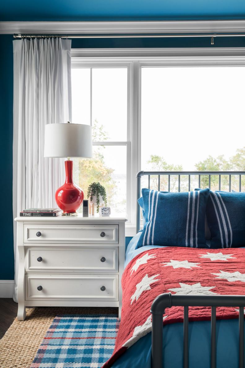 A classic-style three drawer white chest acts as a nightstand on each side of the bed, offering plenty of closed storage for extra pajamas or a throw blanket. The drawers can also hold flat baskets for storing smaller items like a sleep mask or tube of hand cream.