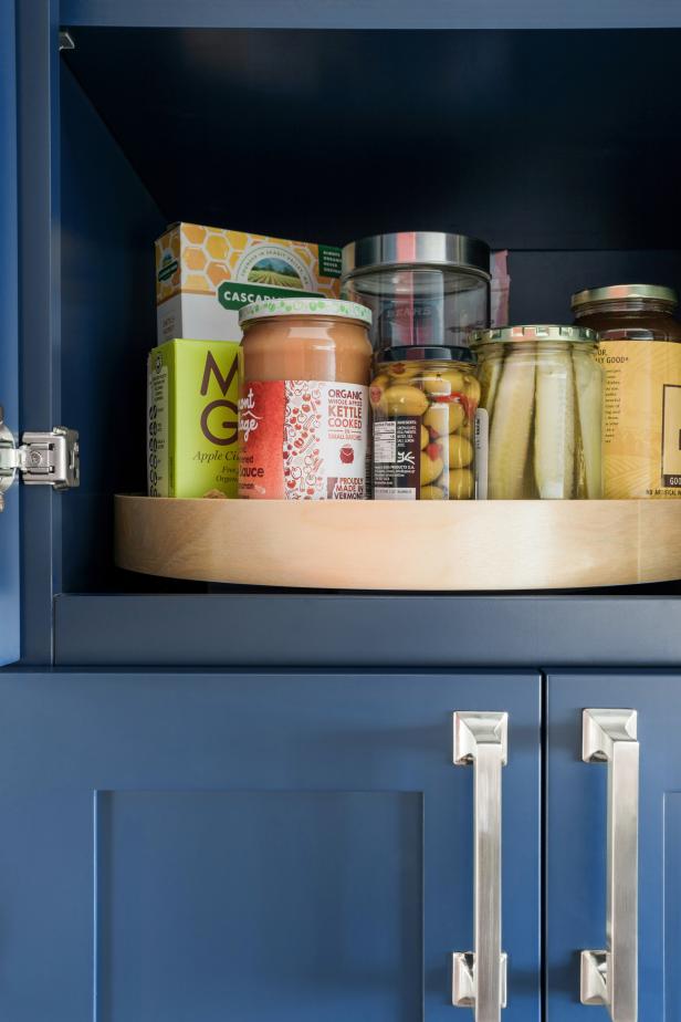 A wooden lazy Susan adds a stylish storage solution to the custom cabinets to make cooking a breeze.