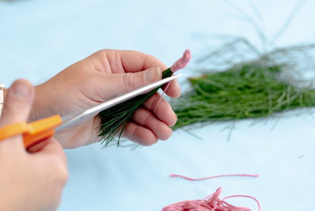 This tassel is made by cutting needles from free greenery and bunching them together using colorful thread.