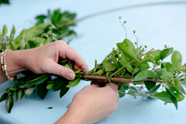 This free greenery is bound to a wreath frame using green floral wire. This is a great way to create inexpensive holiday decorations.