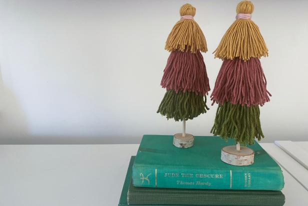 Colorful Yarn Tassel Trees on Stacked Book Display 