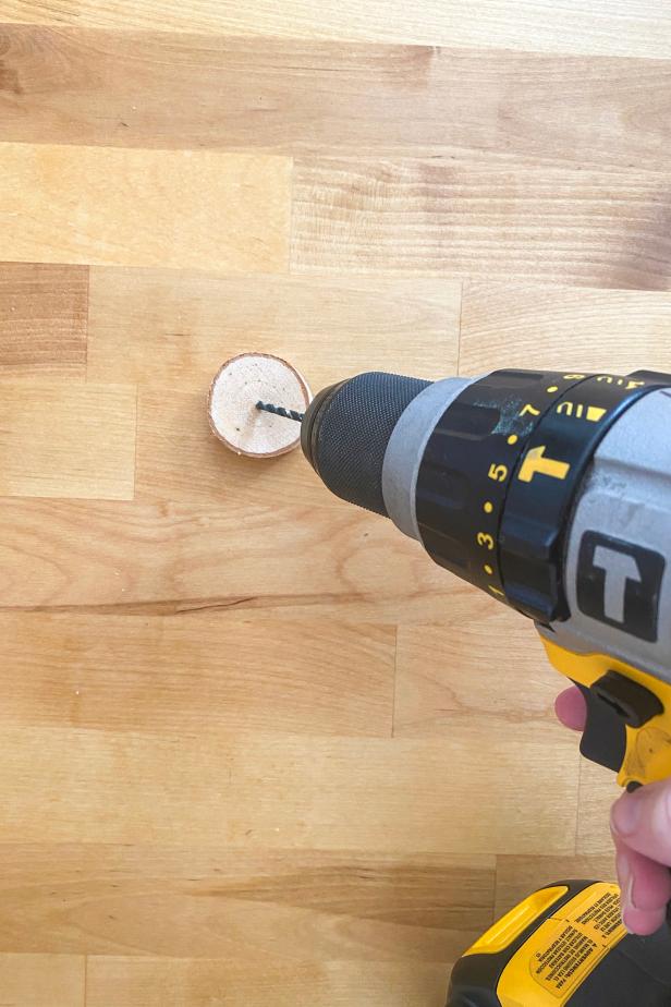 Prepare the base by drilling a small hole halfway into the center of the round wooden disc using an electric drill with a small drill bit. Add a dab of hot glue from a low-temp hot glue gun and place the wire in the hole. Display on a table with others and enjoy!